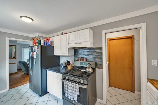 11214 Canal Rd, Sterling Heights, MI 48314 - kitchen featuring appliances with stainless steel finishes, under cabinet range hood, white cabinetry, light tile patterned floors, and tasteful backsplash