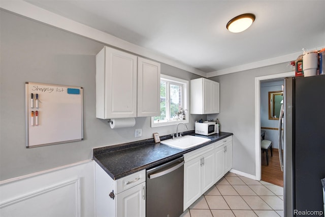 11214 Canal Rd, Sterling Heights, MI 48314 - kitchen featuring stainless steel appliances, dark countertops, white cabinets, and light tile patterned floors