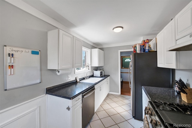 11214 Canal Rd, Sterling Heights, MI 48314 - kitchen with stainless steel appliances, white cabinets, dark countertops, and light tile patterned floors
