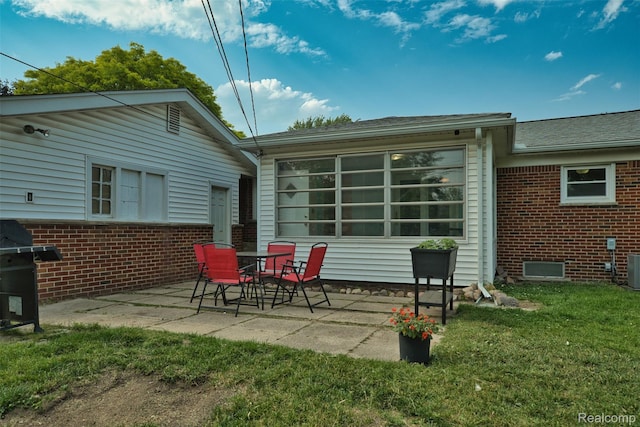 11214 Canal Rd, Sterling Heights, MI 48314 - rear view of house with brick siding, a patio area, and a yard