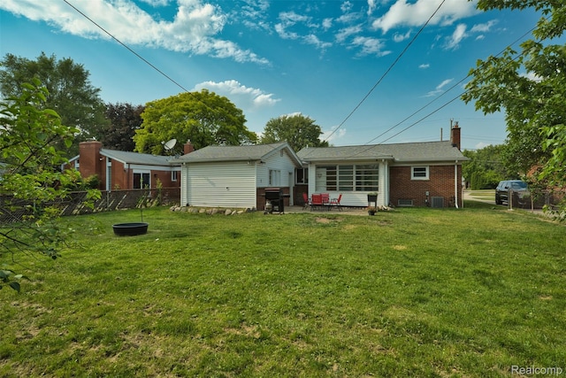 11214 Canal Rd, Sterling Heights, MI 48314 - rear view of house featuring brick siding, a fenced backyard, a patio, and a chimney