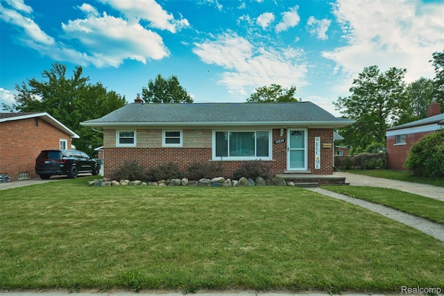 11214 Canal Rd, Sterling Heights, MI 48314 - view of front of home featuring brick siding, a front lawn, a chimney, and roof with shingles
