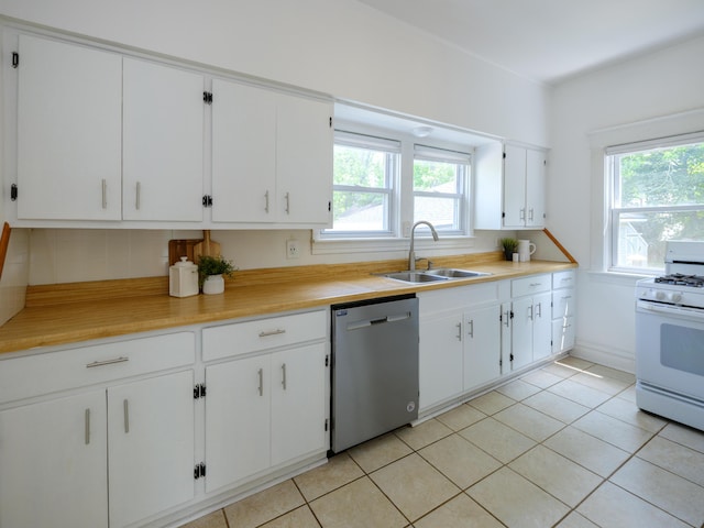 1232 Upland Dr, Kalamazoo, MI 49048 - kitchen featuring stainless steel dishwasher, white gas range, plenty of natural light, and light countertops