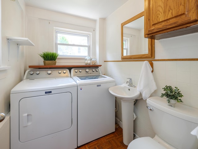 1232 Upland Dr, Kalamazoo, MI 49048 - laundry room with separate washer and dryer and tile walls