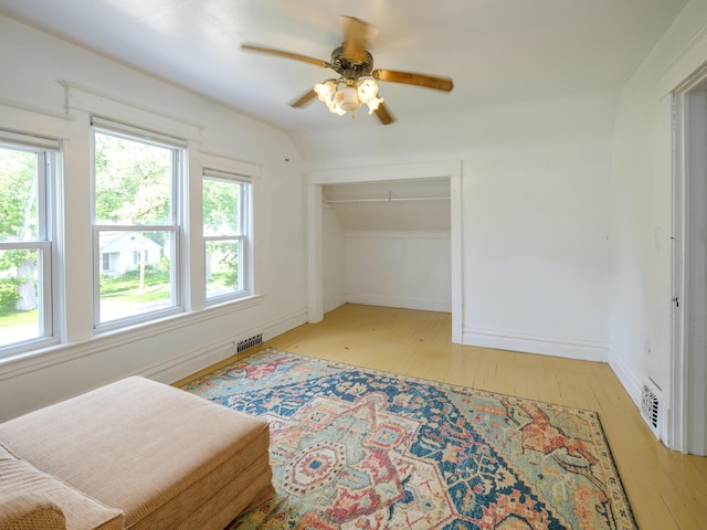 1232 Upland Dr, Kalamazoo, MI 49048 - bedroom featuring light wood finished floors, multiple windows, a ceiling fan, a closet, and lofted ceiling