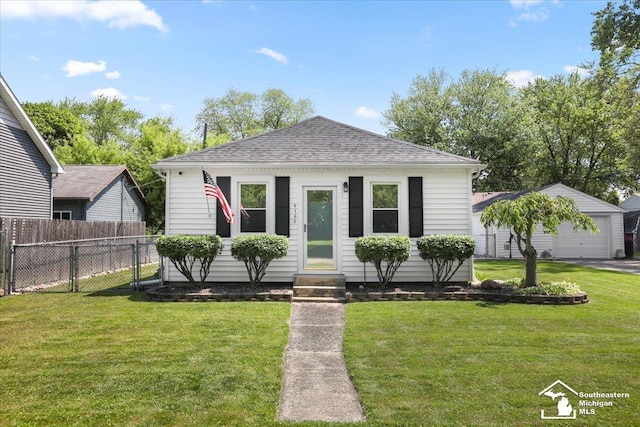 4162 9th St, Newport, MI 48166 - view of front of house featuring entry steps, a shingled roof, an outbuilding, and a garage