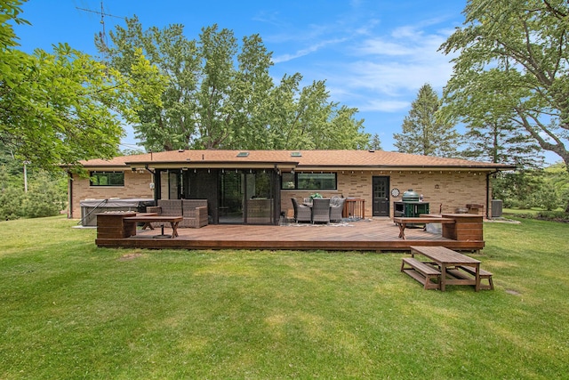 584 Benson Rd, Benton Harbor, MI 49022 - rear view of house with a yard, brick siding, a hot tub, and a deck