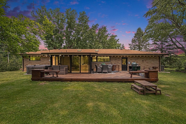 584 Benson Rd, Benton Harbor, MI 49022 - rear view of property featuring an outdoor living space, a hot tub, a lawn, and brick siding
