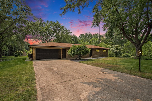 584 Benson Rd, Benton Harbor, MI 49022 - view of front of house featuring an attached garage, driveway, a lawn, and brick siding