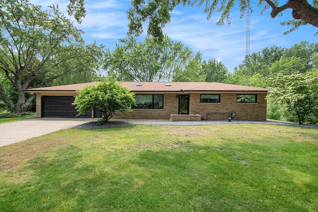 584 Benson Rd, Benton Harbor, MI 49022 - ranch-style house with an attached garage, concrete driveway, a front lawn, and brick siding