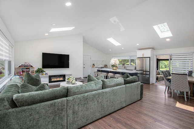 584 Benson Rd, Benton Harbor, MI 49022 - living room with a skylight, lofted ceiling, dark wood-style flooring, a glass covered fireplace, and recessed lighting