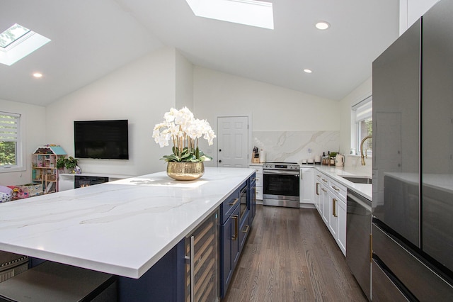584 Benson Rd, Benton Harbor, MI 49022 - kitchen with a skylight, appliances with stainless steel finishes, lofted ceiling, dark wood finished floors, and beverage cooler