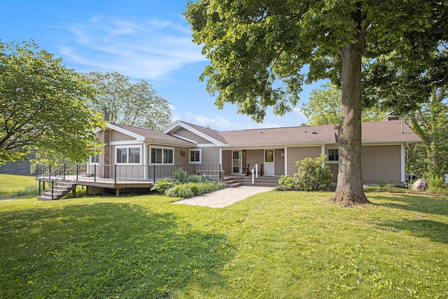 2347 W W Dowling Rd, Delton, MI 49046 - back of property with a lawn, a deck, a patio area, and a chimney