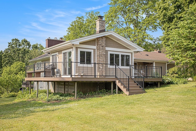 2347 W W Dowling Rd, Delton, MI 49046 - back of property with a chimney, a wooden deck, a yard, and stairway