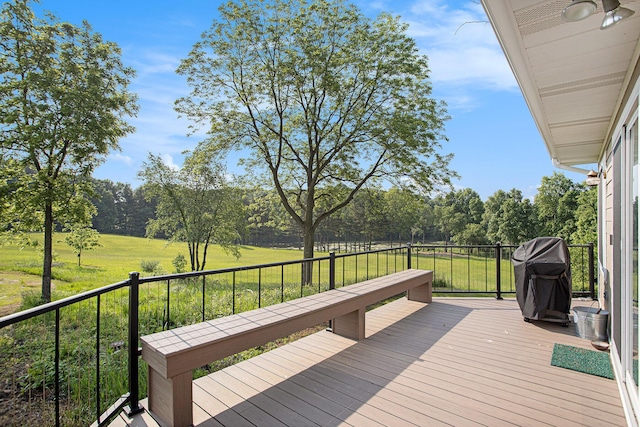 2347 W W Dowling Rd, Delton, MI 49046 - deck with grilling area, a lawn, and view of wooded area
