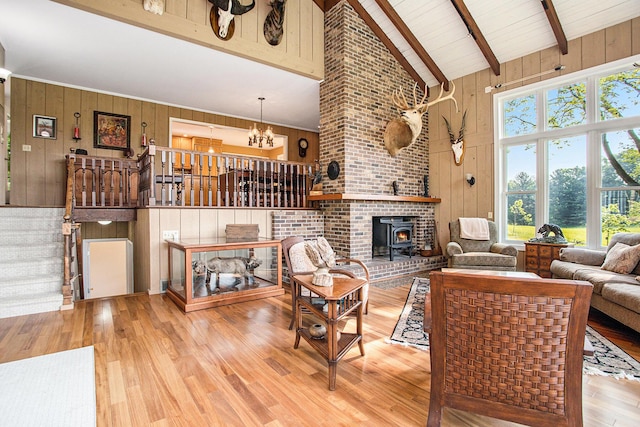 2347 W W Dowling Rd, Delton, MI 49046 - living room featuring wood walls, wood finished floors, beamed ceiling, high vaulted ceiling, and a chandelier