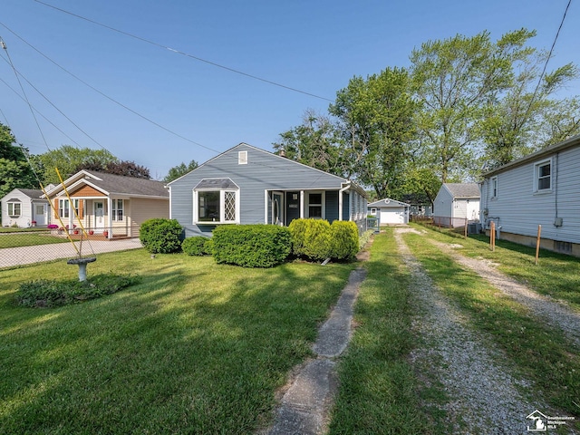 2109 Spaulding Rd, Monroe, MI 48162 - bungalow with driveway, a detached garage, and an outdoor structure
