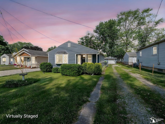 2109 Spaulding Rd, Monroe, MI 48162 - bungalow-style house featuring a garage, driveway, and an outbuilding