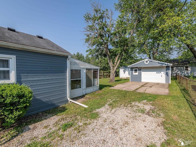 2109 Spaulding Rd, Monroe, MI 48162 - view of yard featuring an outbuilding, a sunroom, a detached garage, and driveway
