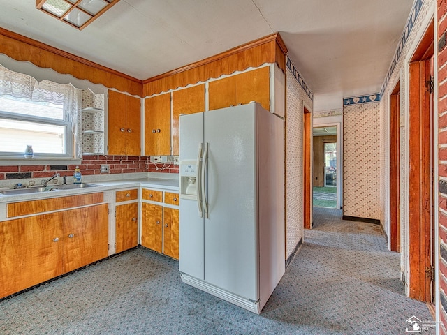 2109 Spaulding Rd, Monroe, MI 48162 - kitchen featuring white refrigerator with ice dispenser, brown cabinetry, and light countertops