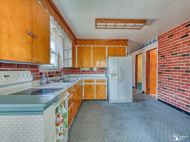 2109 Spaulding Rd, Monroe, MI 48162 - kitchen with white appliances, light carpet, brown cabinetry, light countertops, and brick wall