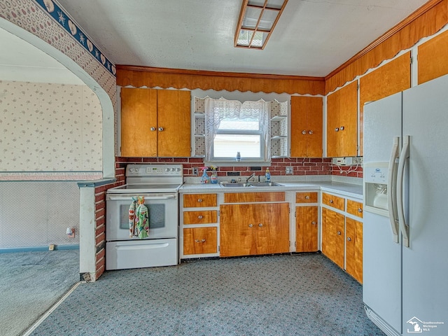2109 Spaulding Rd, Monroe, MI 48162 - kitchen featuring white appliances, brown cabinets, light countertops, and light flooring