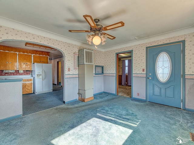 2109 Spaulding Rd, Monroe, MI 48162 - carpeted foyer with wallpapered walls, ceiling fan, arched walkways, wainscoting, and crown molding