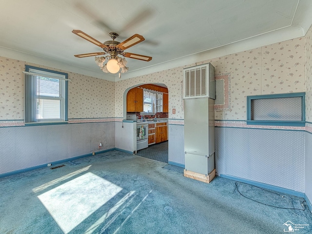 2109 Spaulding Rd, Monroe, MI 48162 - kitchen featuring white electric stove, wallpapered walls, carpet floors, a wainscoted wall, and arched walkways