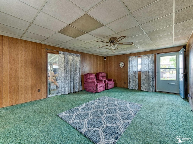 2109 Spaulding Rd, Monroe, MI 48162 - living area with carpet floors, wooden walls, and a ceiling fan