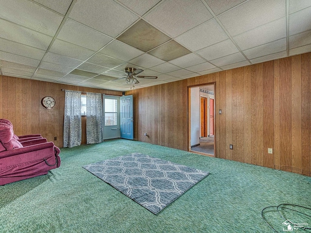 2109 Spaulding Rd, Monroe, MI 48162 - sitting room with carpet flooring, a drop ceiling, wooden walls, and a ceiling fan