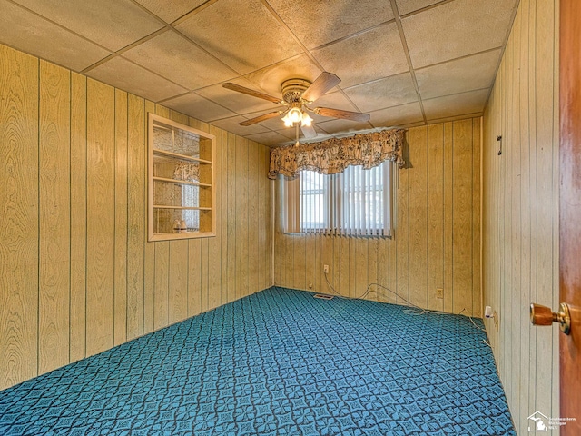 2109 Spaulding Rd, Monroe, MI 48162 - carpeted spare room featuring wood walls and ceiling fan