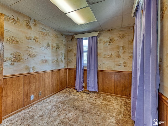 2109 Spaulding Rd, Monroe, MI 48162 - spare room with wainscoting, a paneled ceiling, wood walls, carpet, and wallpapered walls