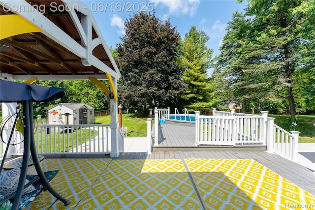 11704 Schram St, Grand Blanc, MI 48439 - view of patio with a storage unit, a deck, an outdoor pool, and view of scattered trees