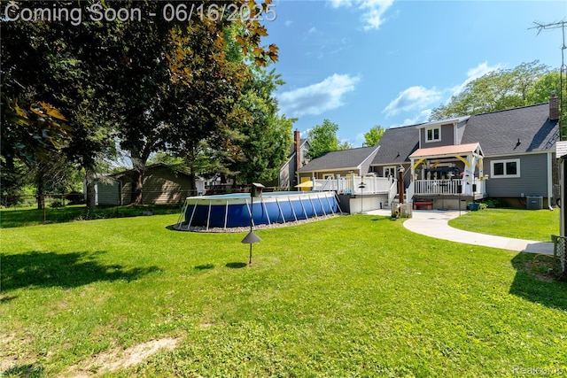 11704 Schram St, Grand Blanc, MI 48439 - view of grassy yard featuring an outdoor pool and a deck