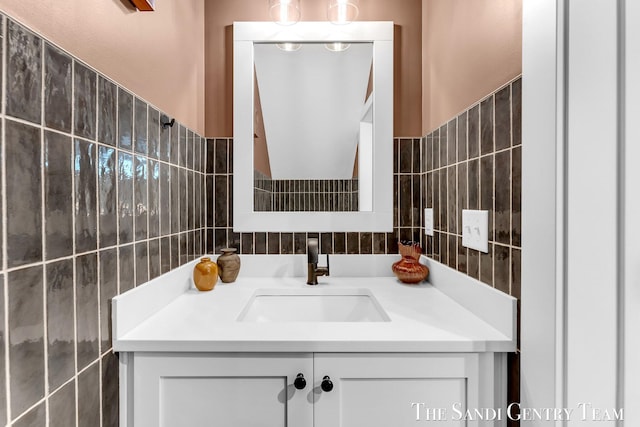 806 S Lake St, Whitehall, MI 49461 - bathroom featuring tile walls, vanity, and tasteful backsplash