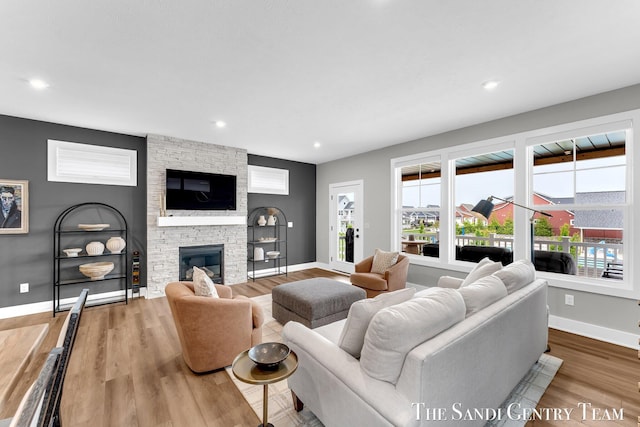 806 S Lake St, Whitehall, MI 49461 - living area with wood finished floors, a fireplace, and recessed lighting