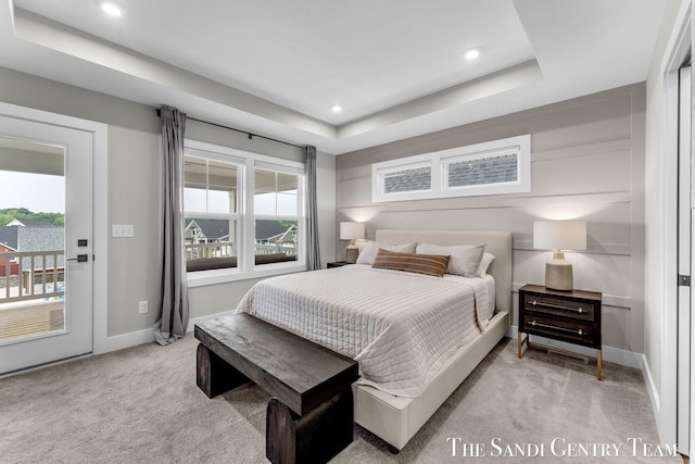 806 S Lake St, Whitehall, MI 49461 - bedroom with light colored carpet, access to exterior, a tray ceiling, and recessed lighting
