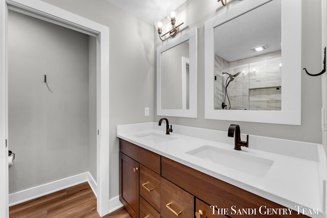 806 S Lake St, Whitehall, MI 49461 - full bathroom with double vanity, a shower stall, and wood finished floors