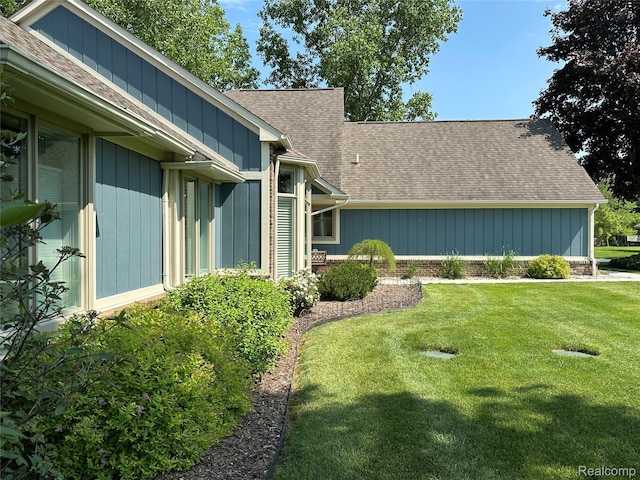 6771 Foxboro, Brighton, MI 48116 - view of property exterior with a shingled roof and a lawn