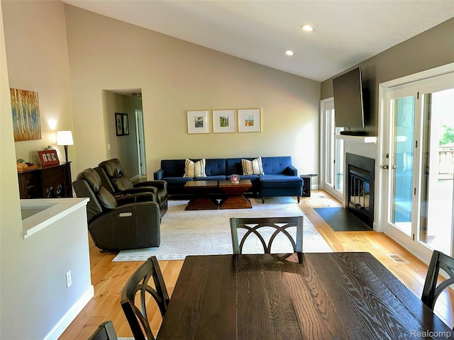 6771 Foxboro, Brighton, MI 48116 - living room with lofted ceiling, light wood-style flooring, a fireplace with flush hearth, and recessed lighting