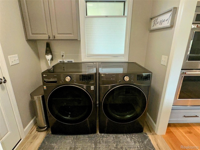 6771 Foxboro, Brighton, MI 48116 - laundry room with washer and clothes dryer, cabinet space, and light wood-style floors