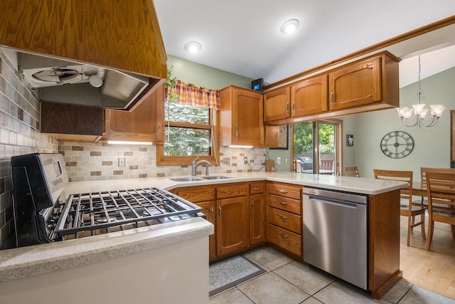 2183 Aaronsway Ct NE, Belmont, MI 49306 - kitchen with appliances with stainless steel finishes, brown cabinetry, light countertops, decorative backsplash, and a chandelier