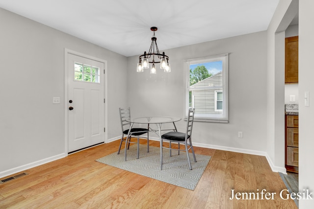 932 Kentfield St SW, Wyoming, MI 49509 - dining area featuring wood finished floors and a chandelier