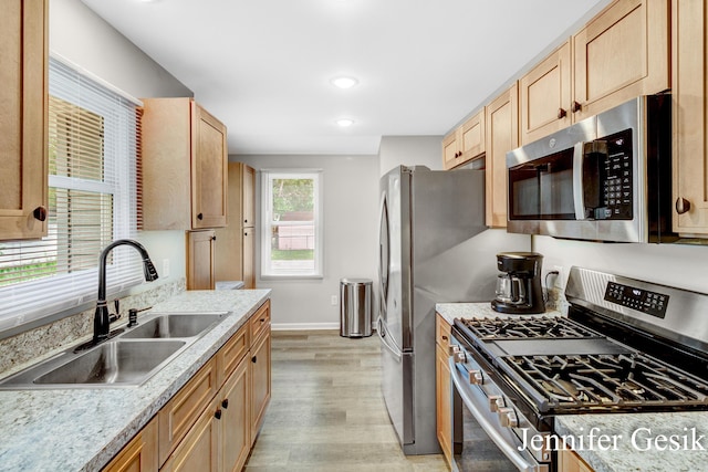 932 Kentfield St SW, Wyoming, MI 49509 - kitchen with appliances with stainless steel finishes, light wood-style floors, light brown cabinetry, light countertops, and recessed lighting