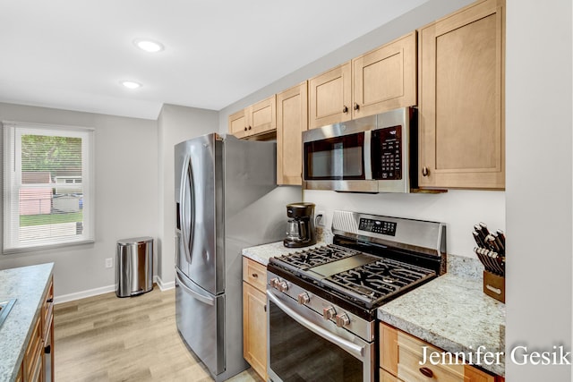 932 Kentfield St SW, Wyoming, MI 49509 - kitchen with appliances with stainless steel finishes, light brown cabinets, light countertops, light wood-style flooring, and recessed lighting
