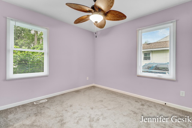 932 Kentfield St SW, Wyoming, MI 49509 - empty room featuring carpet floors, healthy amount of natural light, and a ceiling fan