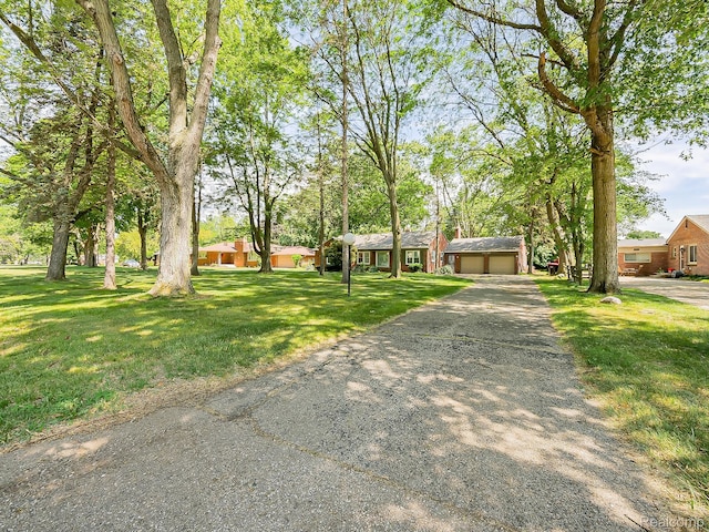 23740 Lee Baker Dr, Southfield, MI 48075 - ranch-style house with an attached garage, driveway, and a front lawn