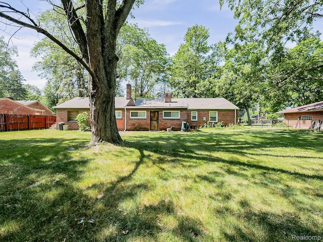 23740 Lee Baker Dr, Southfield, MI 48075 - rear view of house featuring brick siding and a chimney