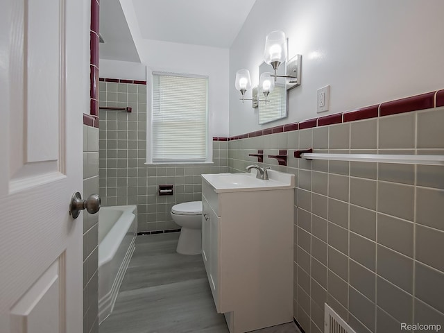23740 Lee Baker Dr, Southfield, MI 48075 - bathroom with tile walls, vanity, wood finished floors, a wainscoted wall, and a chandelier