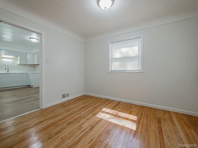 23740 Lee Baker Dr, Southfield, MI 48075 - unfurnished room featuring a sink and light wood-type flooring